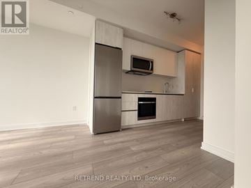 Toronto (Newtonbrook West) condo for rent - A modern kitchen with a stainless steel refrigerator and microwave above the oven.