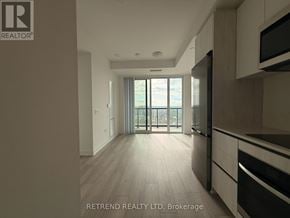 Toronto (Newtonbrook West) condo for rent - A modern kitchen with a view of the city through the sliding glass doors.