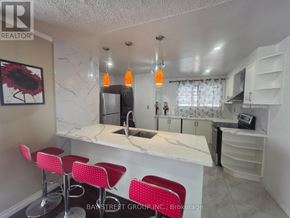 Richmond Hill (Crosby) apartment for rent - A kitchen with a bar area and red stools.