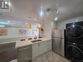 Richmond Hill (Crosby) apartment for rent - A kitchen with a white counter top and a black refrigerator.