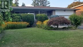 Toronto (Bayview Village) apartment for rent - A well-kept lawn in front of a house with a sign for HomeLife/Bayview Realty Inc. Brokerage.