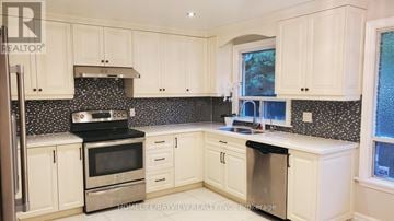 Toronto (Bayview Village) apartment for rent - A kitchen with white cabinets and a black and white backsplash.