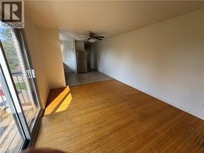 Kitchener apartment for rent - A room with wooden flooring and a ceiling fan.
