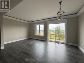 Petawawa townhouse for rent - A spacious room with a sliding glass door leading to a balcony.