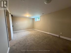 Petawawa townhouse for rent - A room with a carpeted floor and a window with a cross on it.