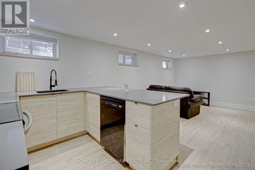 Barrie (Codrington) apartment for rent - A modern kitchen with wooden cabinets and a dishwasher.