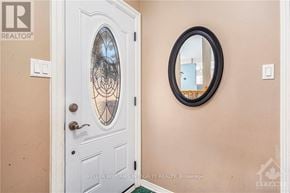 Ottawa townhouse for rent - A white door with a glass window and a round mirror above it.