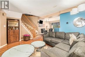 Ottawa townhouse for rent - A living room with a grey couch and a round glass table.