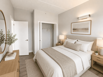 Edmonton apartment for rent - A bedroom with a large bed and a mirror on the wall.