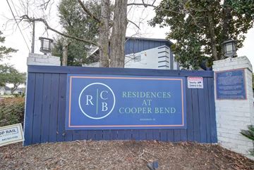 Hanahan apartment for rent - A sign for Residences at Cooper Bend in front of a building.