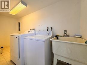 Burnaby apartment for rent - A small bathroom with a washer and dryer.