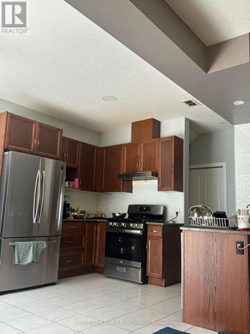 Kitchener apartment for rent - A kitchen with a refrigerator, oven, and cabinets.