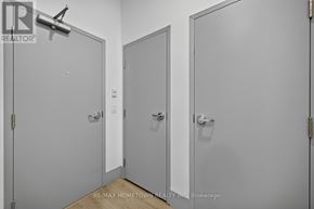 Brockville house for rent - Three white doors in a room with a brokerage sign on the wall.