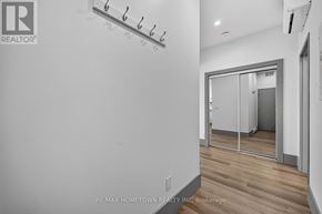 Brockville house for rent - A white wall with a row of hooks on it.