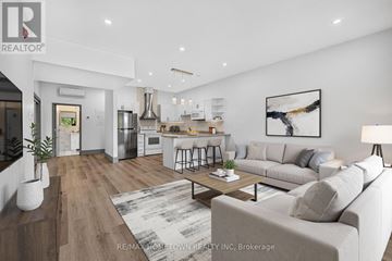 Brockville house for rent - A modern living room with a grey sofa and a wooden floor.