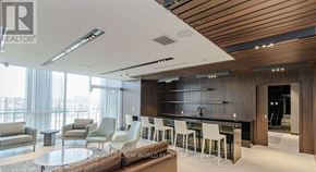 Toronto (Flemingdon Park) condo for rent - A modern living room with a bar area and a dining table.