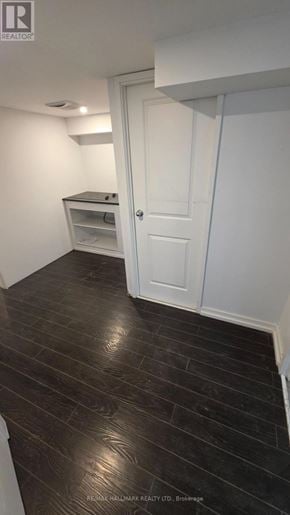 Pickering (Bay Ridges) apartment for rent - A room with a white door and a wooden floor.