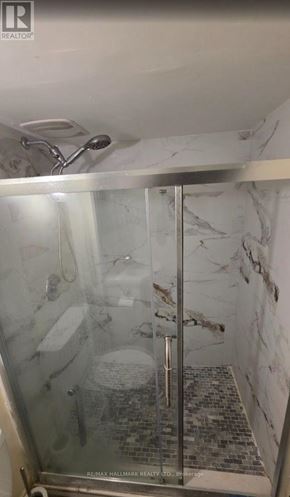 Pickering (Bay Ridges) apartment for rent - A shower with a glass door and a marble wall.