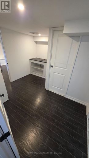Pickering (Bay Ridges) apartment for rent - A room with a white door and a wooden floor.