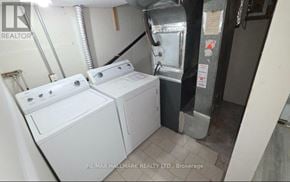 Pickering (Bay Ridges) apartment for rent - A laundry room with a washer and dryer.