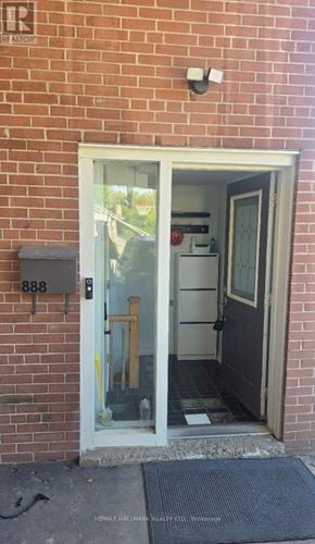 Pickering (Bay Ridges) apartment for rent - A white door with glass panels is open to a room with a red wall.