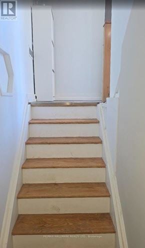Pickering (Bay Ridges) apartment for rent - A staircase with wooden steps and white walls.