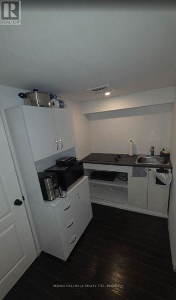Pickering (Bay Ridges) apartment for rent - A small kitchen with white cabinets and a sink.