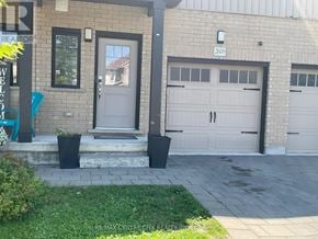 London South (South U) townhouse for rent - A house with a grey front door and a white garage door.