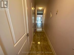 London South (South U) townhouse for rent - A hallway with a door on the left and a picture on the wall.