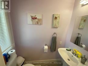 London South (South U) townhouse for rent - A bathroom with a toilet, sink, mirror, and towels.