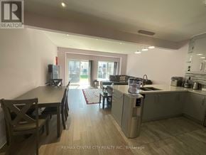 London South (South U) townhouse for rent - A kitchen with a dining table and chairs is shown in the image.