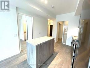 Richmond Hill (South Richvale) condo for rent - A real estate listing photo of a modern kitchen with a wooden island.