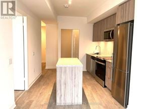 Richmond Hill (South Richvale) condo for rent - A kitchen with a wooden island in the middle.