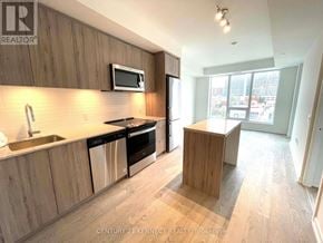 Richmond Hill (South Richvale) condo for rent - A kitchen with wooden cabinets and a microwave above the stove.