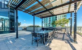 Mississauga (City Centre) condo for rent - A patio with a table and chairs under a wooden roof.