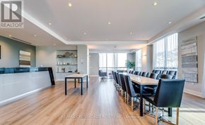 Mississauga (City Centre) condo for rent - A modern dining room with a long table and chairs.