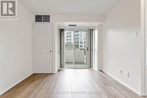 Toronto (Clanton Park) condo for rent - A white door with a window above it in a room with wooden floors.