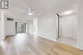 Toronto (Clanton Park) condo for rent - A spacious room with a ceiling fan and sliding glass doors.