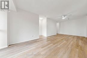 Toronto (Clanton Park) condo for rent - A room with wooden flooring and white walls.