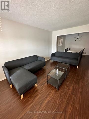 Toronto (Eglinton East) apartment for rent - A living room with a black couch and a glass coffee table.