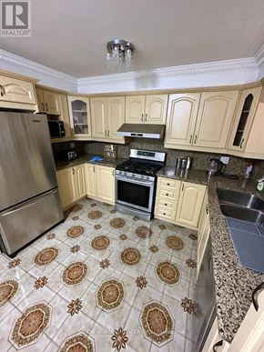 Toronto (Eglinton East) apartment for rent - A kitchen with a tile floor and a refrigerator.
