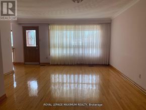 Vaughan (West Woodbridge) apartment for rent - A room with wooden flooring and a door with a stained glass window.