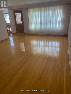 Vaughan (West Woodbridge) apartment for rent - A room with wooden flooring and a door with a decorative design on it.