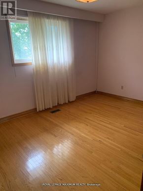 Vaughan (West Woodbridge) apartment for rent - A room with wooden flooring and a window with curtains.