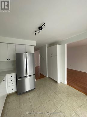 Barrie (Painswick South) apartment for rent - A kitchen with a refrigerator and cabinets.