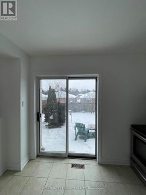 Barrie (Painswick South) apartment for rent - A room with a sliding glass door that leads to a snowy landscape.