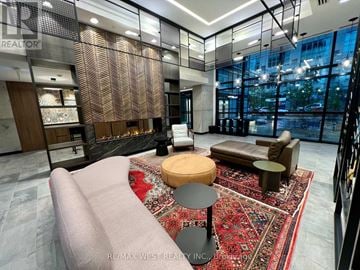 Toronto (Mimico) condo for rent - A modern living room with a large sofa and a rug.