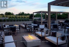 Hamilton (Ancaster) condo for rent - A patio with a fire pit and seating area.