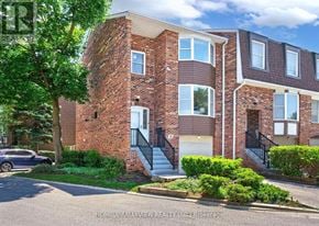 Markham (German Mills) townhouse for rent - A brick apartment building with a car parked in front.