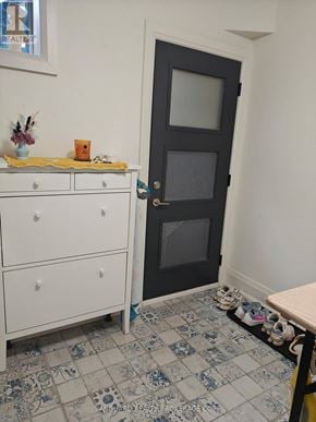 Toronto (Dovercourt-Wallace Emerson-Junction) triplex for rent - A white dresser with a yellow cloth on top of it and a black door.